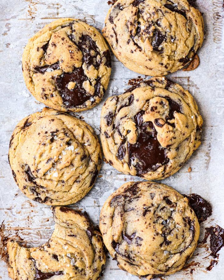 chocolate chip cookies sitting on top of a baking sheet