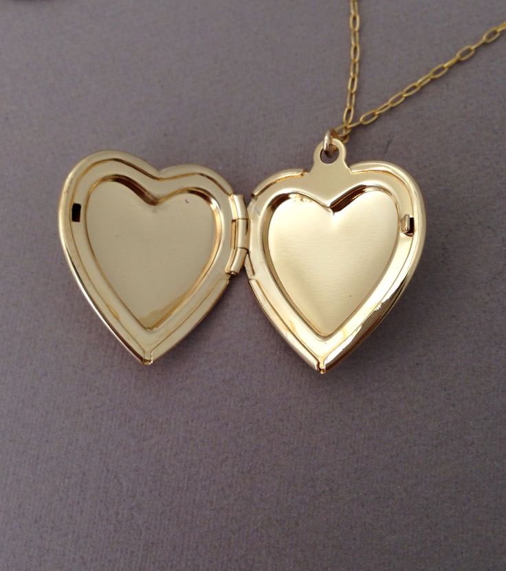 Cute gold locket hangs on a 14k gold fill chain. Locket measures 3/4ths of in inch in width. Locket is a gold overlay which is stronger than a gold plate and will not change colors if taken care of. LENGTH - Necklace on the model is 20 inches (the model's neck circumference is 12 inches). YOUR ORDER - Choose either gold fill or sterling silver in the drop-down menu. - Select the length in the drop-down menu. If you want less than 16 inches, let me know when you checkout. - Add a Chain Extender f 14k Gold Locket Jewelry For Valentine's Day, 14k Gold Heart Locket Jewelry, Heart-shaped 14k Gold Locket, 14k Gold Heart-shaped Locket, Valentine's Day 14k Gold Locket Jewelry, Gold Heart Charm Locket Necklace, Gold Locket Necklace With Charms, Gold Round Locket Necklace With Heart Charm, Gold 14k Gold Charms Locket Necklace