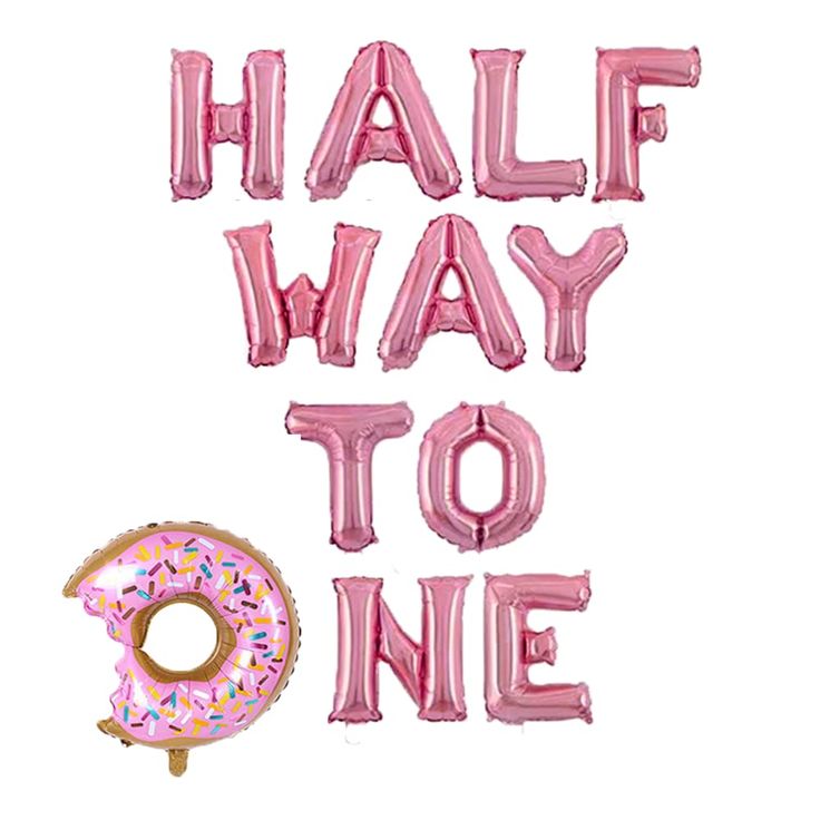 the phrase half way to one is made out of pink foil balloons and a donut