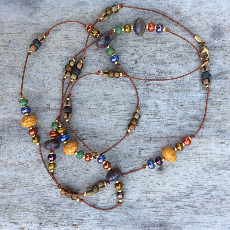 "✦This carefully designed long multi colored Czech rondelle beaded necklace in glossy  blue, red, greens, gold, matte charcoal grey and beige stripped beads, is complimented with larger Czech beads in Picasso red and yellow with solid brass spacer beads enhance the design.  Necklace is on a natural strong cord. ✦Fashionable versatile bohemian long necklace has a clasp, which can be doubled into a short strand necklace. This piece will go with many outfits. Just throw on over your dress. Dress it Boho Necklaces Bohemian Bead, Long Beaded Necklace Ideas, Boho Necklace Diy, Bohemian Jewelry Diy, Boho Beaded Necklace, Long Boho Necklace, Earthy Necklace, Boho Jewelry Diy, Beaded Boho Necklace