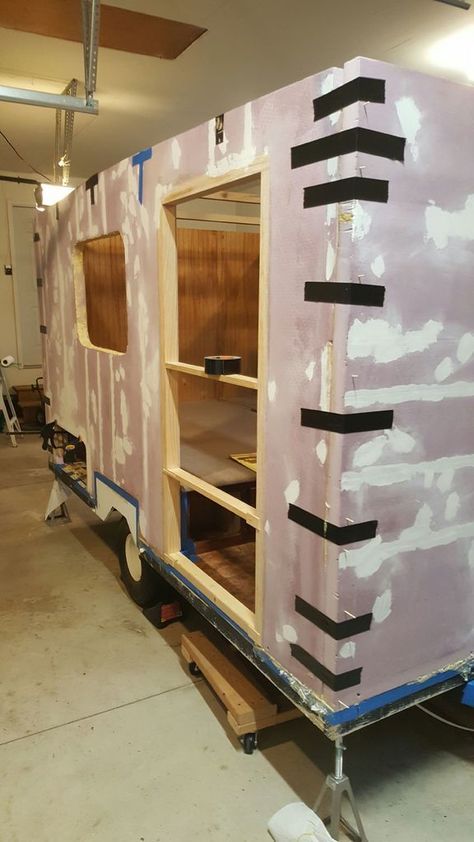 a trailer is being built in the middle of a room with some paint on it