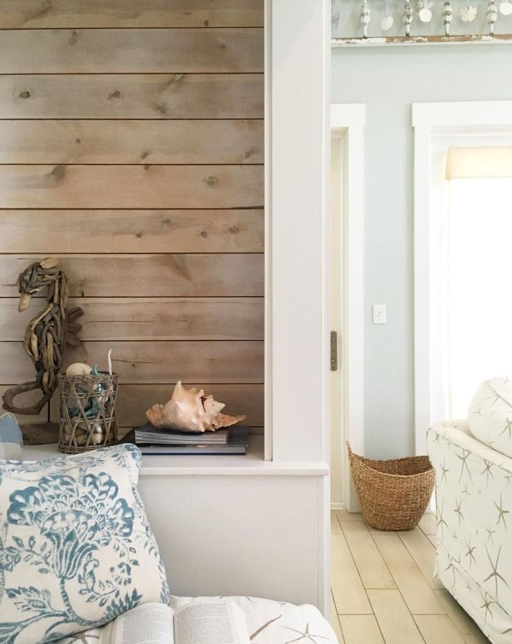 a living room filled with furniture and wooden walls