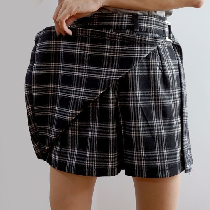 Plaid shorts with a belted skirt overlay and concealed side zipper. S: 26" waist, 15.5" length M: 27.5" waist, 15.5" length L: 29" waist, 15.5" lengthXL: 30.5" waist, 16" length2XL: 32" waist, 16" length3XL: 33.5" waist, 16" length4XL: 35" waist, 16.5" length5XL: 36.5" waist, 16.5" length High Waist Mini Skirt With Belt For Summer, Summer High Waist Mini Skirt With Belt, Trendy Short Skirt With Belt Loops, Summer High Waist Belted Skort, Summer High-waist Belted Skort, Trendy Belted Skort For Summer, Trendy Summer Skort With Belt, Summer Asymmetrical Skirt With Belt Loops, Chic Mini Length Bottoms With Belt Loops