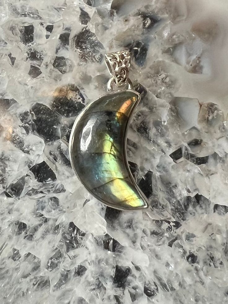 A fiery full spectrum labradorite stone cut into a crescent moon and simply set in sterling silver. A great gift for any witch in you life! Learn more about our shop at www.golddoorpdx.com follow us on Facebook or Instagram for more! Celestial Silver Labradorite Jewelry, Spiritual Moon Shaped Gemstone Jewelry, Mystical Labradorite Healing Jewelry, Mystical Labradorite Jewelry For Healing, Moon Shaped Gemstone Spiritual Jewelry, Spiritual Moon-shaped Gemstone Jewelry, Silver Labradorite Jewelry With Moon Charm, Handmade Magical Labradorite Jewelry, Iridescent Labradorite Pendant Jewelry