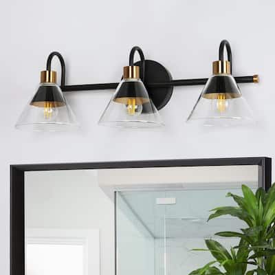 a bathroom with a mirror and two lights on the wall next to a potted plant