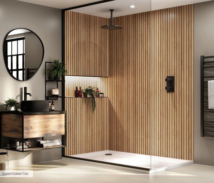 a bathroom with a shower, mirror and wooden paneling on the wall behind it