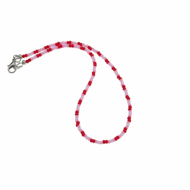 "Cute red and pink seed bead choker necklace is perfect for Valentines Day or any other special occasion. This cute pink choker showcases tiny red, pink and white glass seed beads in an eye catching pattern. Sturdy lead and nickel free lobster clasp ensures a secure and comfortable fit. The charming pink beaded necklace will make an excellent gift for women. Measurements(approx, see 3rd photo) Necklace Length:14\"(including clasp) Beads:3 mm" Valentine's Day Gift Pink Beaded Necklaces, Red Heart Beads For Gifts, Handmade Pink Beaded Necklaces For Valentine's Day, Pink Handmade Beaded Necklace For Valentine's Day, Red Beaded Chain Necklace For Valentine's Day, Adjustable Single Strand Red Beads, Red Heart Beads For Jewelry Making, Red Choker Necklace With Colorful Beads, Pink Beaded Necklace With Tiny Beads For Gift