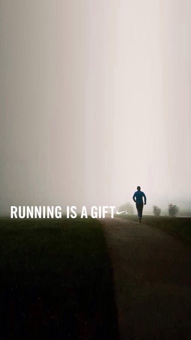 a man is running in the foggy field with his back turned to the camera