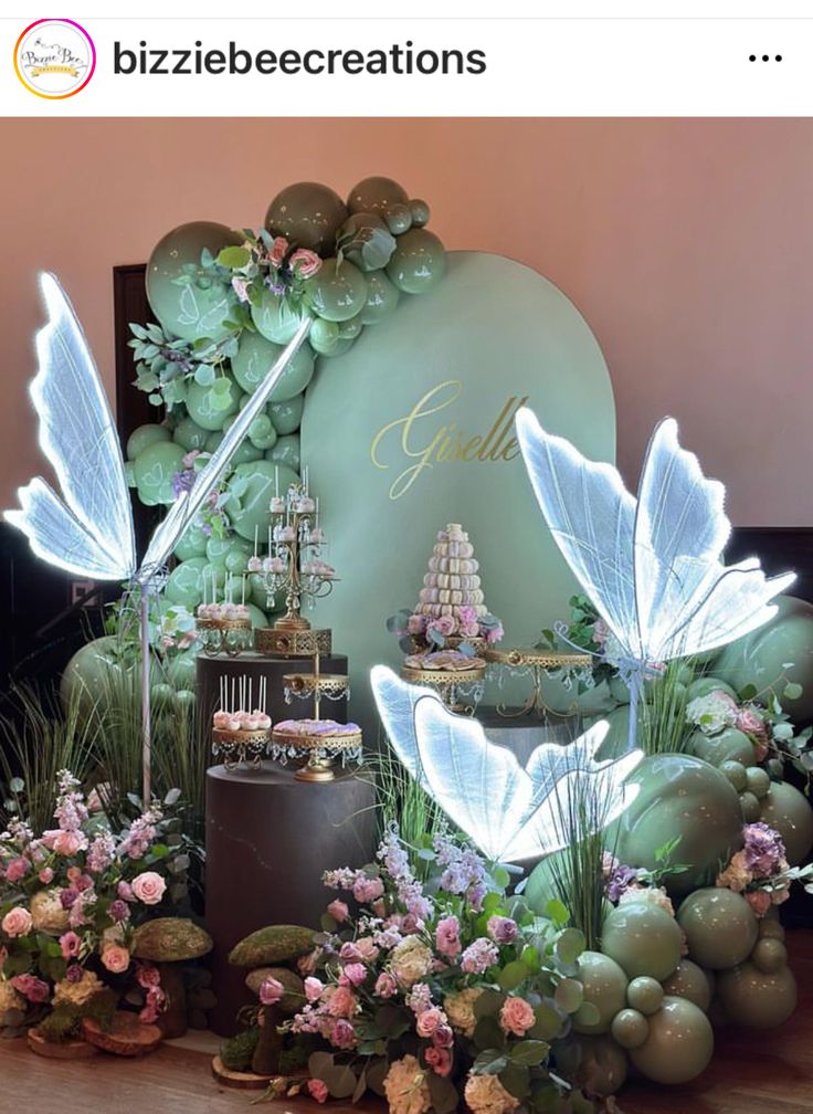 a table topped with lots of flowers and fairy decorations