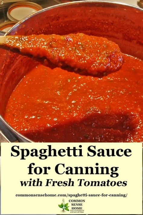 spaghetti sauce for canning with fresh tomatoes in a large metal pan on top of a stove