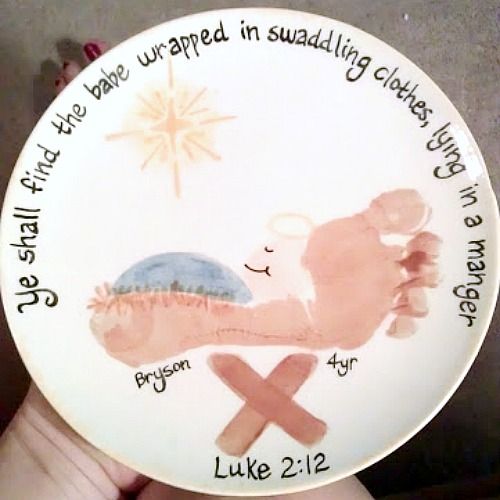 someone is holding up a plate with the birth of jesus on it