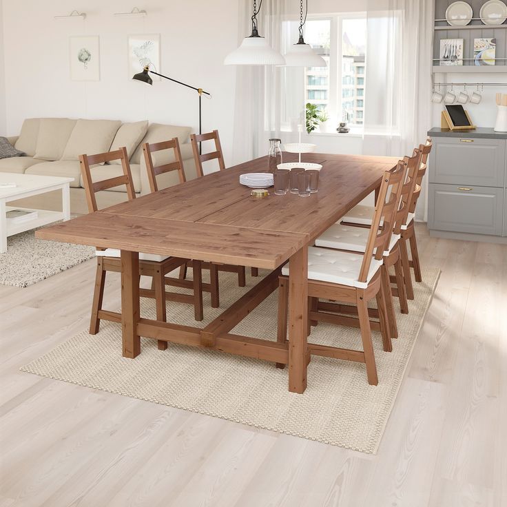 a dining room table with six chairs and a bench in the middle of the room