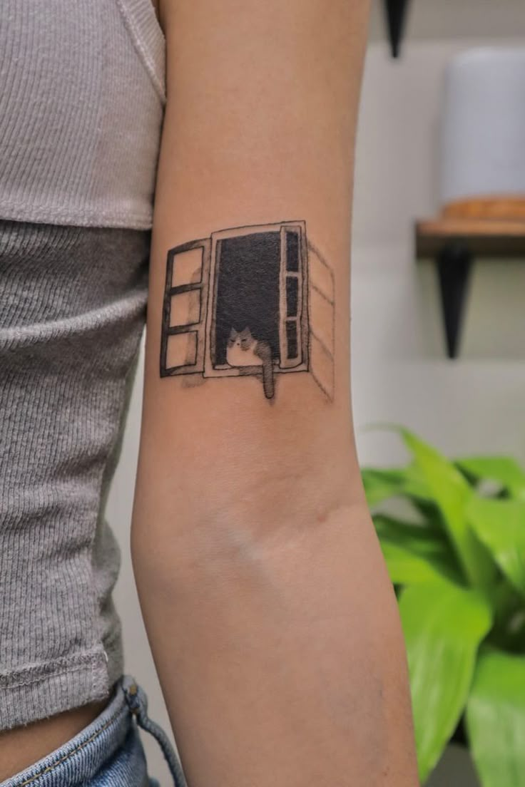 a woman's arm with a black and white drawing of a microwave on it