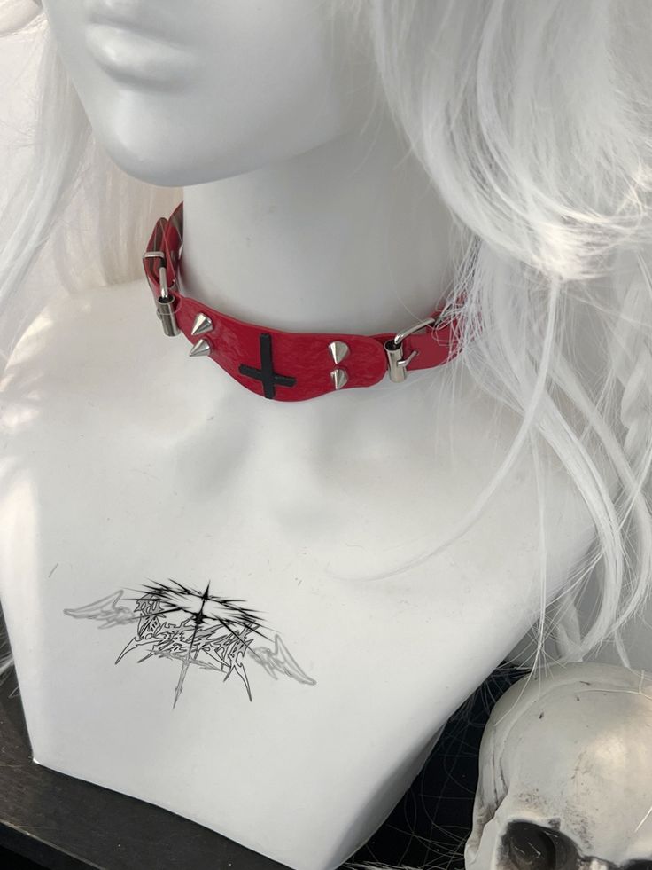 This red choker features a decorative inverted cross pendant adorned with studs. Add a touch of edgy style to your look with this statement piece. Perfect for adding a bold and unique touch to any outfit, this choker is a must-have accessory for those who love to stand out. Made with high-quality materials, it is both durable and eye-catching. Ideal for those who love to express their individuality through fashion.  The price is for a choker only, others are not included. Red Punk Choker For Festivals, Alternative Style Choker For Cosplay, Red Punk Jewelry For Festival, Red Emo Choker Jewelry, Red Gothic Choker For Festivals, Red Emo Style Choker Jewelry, Punk Choker For Halloween Festival, Punk Halloween Festival Choker, Trendy Choker For Halloween And Alternative Fashion