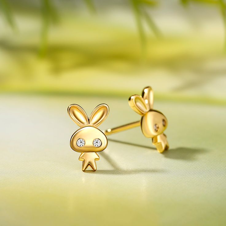 Whimsical and ever playful, these tiny earrings are the sweetest thing you'll ever set your eyes on! With two long ears, shimmering eyes and little body, the design creatively keeps all the cuteness of a bunny rabbit. These adorable woodland rabbit earrings are perfect to give as a gift for someone you love, or as a little treat for yourself!Carat Weight: 0.074 ctStone Size: 1.3 mmStone Type: Jeulia® StoneNumber of Stones: 4 Stone Shape: RoundStone Color: Diamond WhiteWeight: 1.56 gMaterial: Pla Huggie Plug Earrings For Gifts, Novelty Gold Earrings, Small Gold Cute Earrings, Charming Earrings For Pierced Ears As Gift, Charming Earrings As A Gift, Cute Gold Sterling Silver Earrings, Tiny Cute Sterling Silver Earrings, Cute Huggie Jewelry Gift, Cute Tiny Sterling Silver Earrings