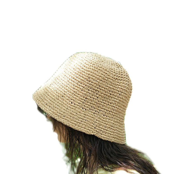 This hat is handmade and crafted from raffia yarn. Raffia yarn is a natural and durable material, ensuring the hat's longevity. The beige color and simple design make it an ideal accessory for both everyday use and outdoor activities like the beach. The wide-brim bucket shape provides sun protection and offers a stylish look. Its comfortable and lightweight structure ensures easy and prolonged wear. Raffia. You can store this hat, knitted from raffia rope, in a breathable cloth bag, protect it from fire and heat, and wipe the stains with a clean damp cloth. Eco-friendly Toquilla Straw Hat, Natural Straw Bucket Hat With Flat Brim, Natural Woven Wide Brim Bucket Hat, Wide Brim Natural Woven Bucket Hat, Wide Brim Woven Bucket Hat In Natural, Natural Woven Bucket Hat With Short Brim, Lightweight Natural Straw Hat, Lightweight Beige Straw Hat With Flat Brim, Natural Straw Hat With Natural Fiber