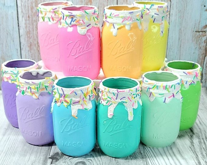 colorful mason jars with confetti and sprinkles are arranged in a circle