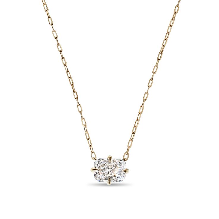 a diamond necklace on a chain with a gold tone finish and an oval cut stone in the center