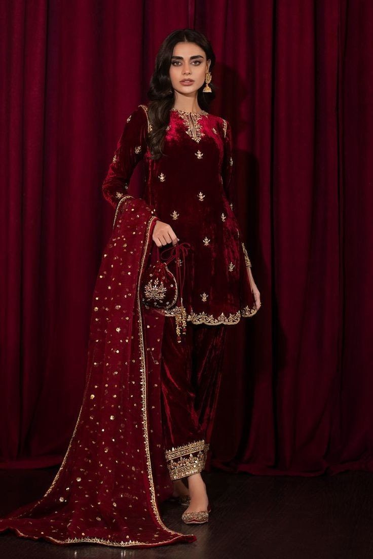 This Attractive Red velvet hand Embroidered A- line Kurti paired with straight Salwar has matching red dupatta with lace border and small motifs all over the dupatta. This 3-piece Salwar Kameez dress that effortlessly blends tradition with contemporary flair. This beautiful short knee length Kurti set is meticulously crafted for women who appreciate the beauty of intricate details and sophisticated design. For any kind of customization i.e. fabric/color/style and size please message us. Care Ins Bollywood Style Velvet Sharara For Navratri, Festive Embroidered Velvet Sharara, Bollywood Style Velvet Traditional Wear For Eid, Traditional Red Velvet Sharara, Red Velvet Traditional Sharara, Eid Velvet Saree Sets, Velvet Salwar Kameez For Eid Festivities, Velvet Sharara With Resham Embroidery For Navratri, Navratri Velvet Sharara With Resham Embroidery