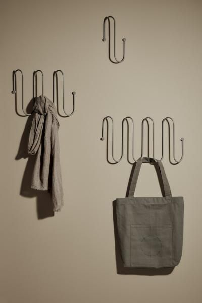 two hooks are hanging on the wall next to a bag