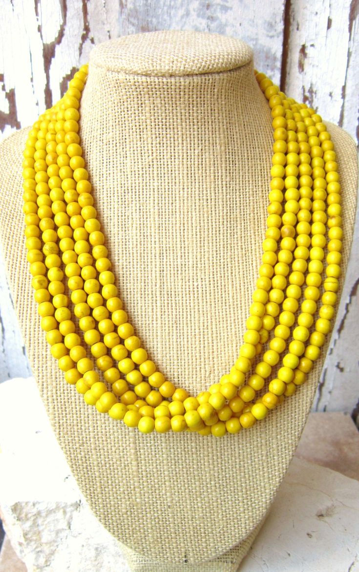 "Beautiful sunny yellow howlite stones make up this stunning necklace. A beautiful mixture of yellow and gold colors with a hint of brown crackle matrix running throughout the stones. The stones measure 5mm round and are about the size of a small pea. The length measures 18\" and has a large silver lobster claw closure. The necklace can be adjusted up to a 20\" length with the 2\" silver extender chain. Choose from 1 strand all the way up to 5 strands, as shown. The necklace is strung on a 49 st Yellow Multi-strand Beaded Necklace, Luxury Yellow Single Strand Necklace, Luxury Yellow Single Strand Jewelry, Yellow Wooden Beads For Jewelry Making, Yellow Gemstone Beaded Necklaces, Yellow Bohemian Necklace With Faceted Beads, Yellow Gemstone Beaded Necklaces For Gifts, Howlite Jewelry, Turquoise Statement Necklace