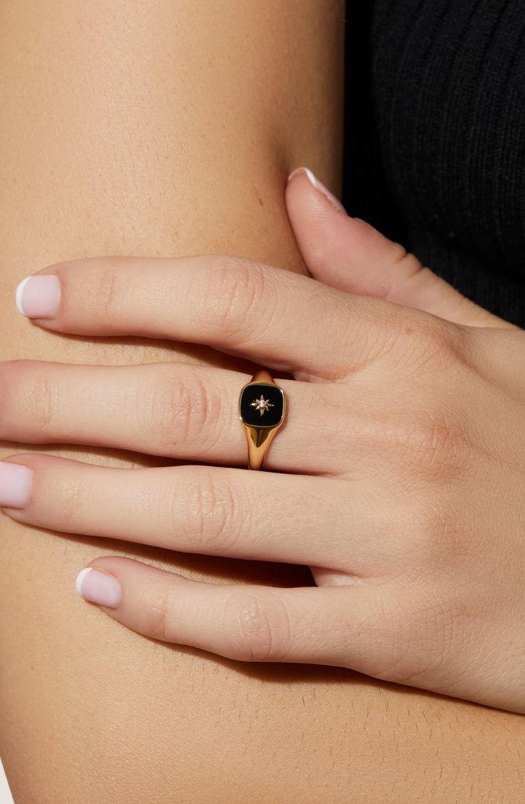 We heard you love bold accents, so we made you this gold signet ring to amp up your seasonal wardrobe. This bold ring is dipped in 14K gold and features an onyx stone beneath a unique star symbol. Wear this gold signet ring with our Amara Mother of Pearl ring for a juxtaposed look. Dipped in 14K gold Features an onyx stone Depth: 3.41mm - 0.13” Weight: 2.24g Crafted In China Gold And Onyx Ring, Onyx Ring Women, Floral Signet Ring, Onyx Gold Ring, Black And Gold Wedding Ring For Women, Gemstone Rings Aesthetic, Black Onyx Signet Ring, Black Rings Aesthetic, Signant Ring