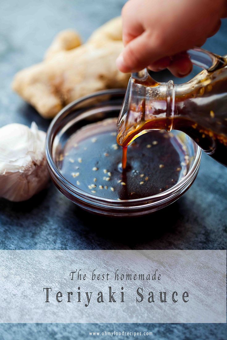 someone pouring sauce into a bowl next to garlic