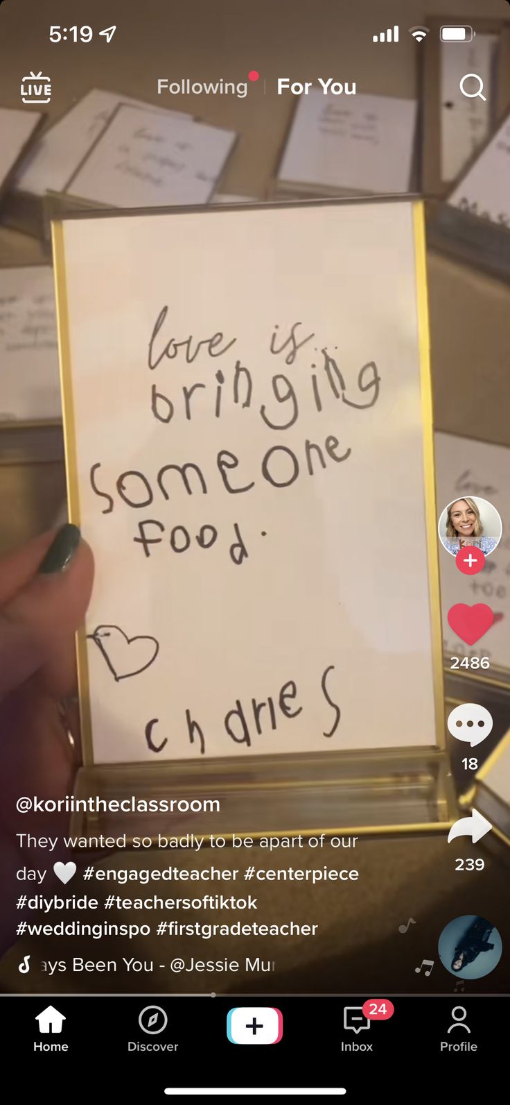 someone is holding up a sign that says, love is bringing someone food to others