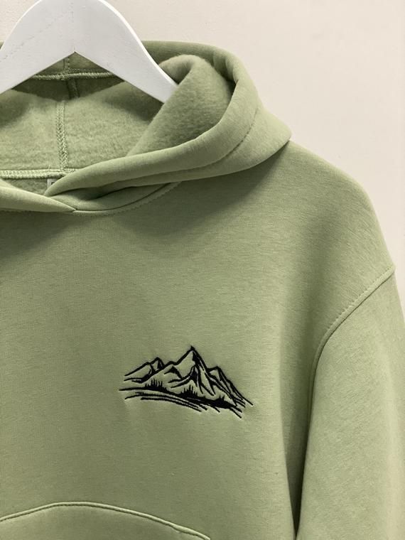 Embroidered Mountains hoodie, sweatshirt, and t-shirt for Gift.It's an original and creative idea of the present for Traveler Lover Fan.------------------------------------------------------• HOODIE/SWEATSHIRT •Material:∘ 70% cotton∘ 30% polyesterSize:∘ women: S, M, L∘ man:S, M, L, XL, XXLColors:∘ women: black, white, pink, light green, beige, blue wave, melange∘ man: black, white, beige, melange, khaki------------------------------------------------------• T-SHIRT •Material:∘ 95% cotton∘ 5% ela Winter Hoodie With Embroidered Logo And Crew Neck, Winter Crew Neck Hoodie With Embroidered Logo, Winter Embroidered Logo Crew Neck Hoodie, Winter Crew Neck Hoodie With Embroidered Graphics, Winter Crew Hoodie With Letter Embroidery, Winter Hoodie With Letter Embroidery And Relaxed Fit, Crew Hoodie With Letter Embroidery For Winter, Green Long Sleeve Hoodie With Embroidered Graphics, Green Embroidered Long Sleeve Hoodie