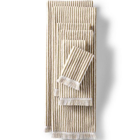 three striped towels with fringes on them