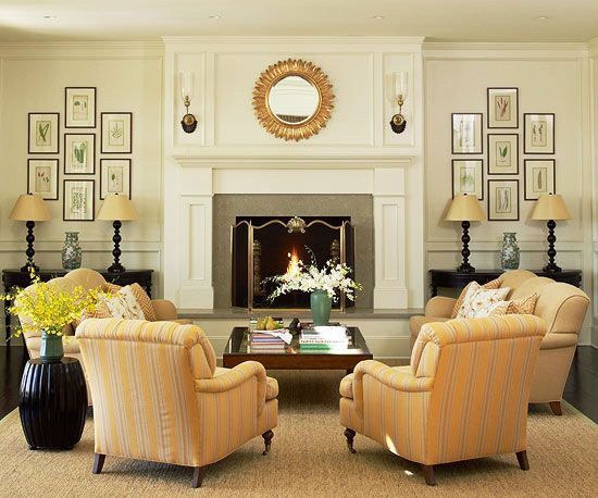 a living room filled with furniture and a fire place in front of a wall mounted fireplace