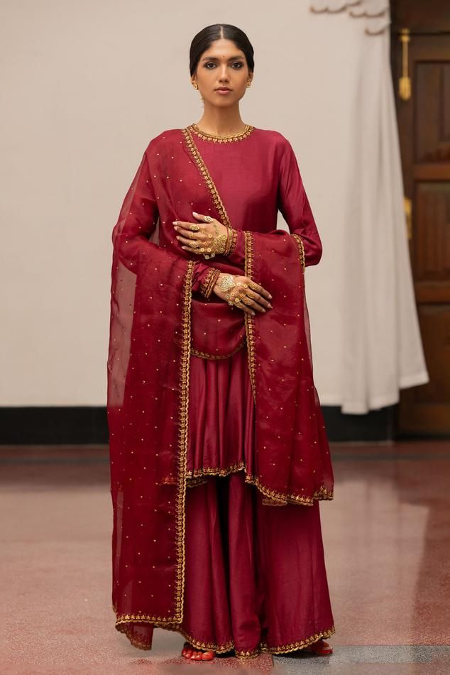 Burgundy anarkali with woven, floral sequin embroidery detailing. Paired with sharara and dupatta.
Components: 3
Pattern: Embroidered, Woven
Type Of Work: Floral
Neckline: Round
Sleeve Type: Full
Fabric: Kurta, Sharara: Munga Silk, Dupatta: Organza Silk
Color: Wine
Other Details: 
Embroidered dupatta
Model height: 5ft 7inches, wearing size S
Length: 39 inches
Occasion: Puja - Aza Fashions Eid Reception Sharara With Dabka Work, Chinon Sharara For Reception And Eid, Eid Reception Sharara In Chinon, Eid Reception Chinon Sharara, Bollywood Style Chinon Kurta For Reception, Anarkali Style Sharara With Zari Work For Reception, Transitional Season Dola Silk Salwar Kameez For Reception, Bollywood Style Chinon Salwar Kameez For Reception, Dola Silk Traditional Drape Palazzo Set For Reception