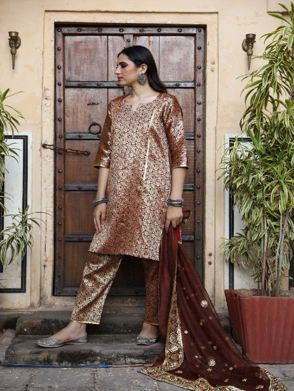 With festivals around the corner, wardrobe update is mandatory. Presenting brocades like never before. Made in straight silhouette with narrow pants and organza dupatta, which is beautified with lovely hand work. Taari and gotta detailing on dupatta is just the right touch. Color: Brown Fabric: Kurta & Bottom- Brocade Dupatta - Organza Note: Length and sizes can be customised Length - Kurta 40 inches Pants 38 inches Available in other colors If you happen to see some deformity in hand-work or fa Festive Anarkali Sets In Brocade, Festive Anarkali Brocade Sets, Eid Brocade Sets With Resham Embroidery, Festive Designer Brocade Unstitched Suit, Festive Brocade Unstitched Suit With Resham Embroidery, Festive Jamawar Palazzo Set With Dupatta, Festive Straight Kurta Churidar In Tissue Silk, Unstitched Brocade Sets For Designer Wear, Brocade Unstitched Suit With Resham Embroidery For Eid