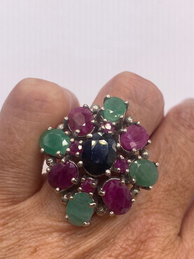 Rich and very bright ring blue sapphire surrounded by Emerald and ruby  Sterling silver  Size 5.5 can be sized by my jeweler. His service charge is $20  All rings are shipped in a nice gift box.   Check out our over a THOUSAND great reviews Engraving is $4 per letter and is not always perfect depending on the piece. It can take a few days if the jeweler is busy. This is payable to Paypal Judithsltd@gmail.com Multicolor Sapphire Ring For Formal Occasions, Formal Multicolor Round Sapphire Ring, Multicolor Round Emerald Ring Fine Jewelry, Multicolor Round Sapphire Gemstones, Multicolor Ruby Ring In Fine Jewelry Style, Multicolor Ruby Ring Fine Jewelry, Multicolor Ruby Ring With Gemstone, Multicolor Round Ruby Ring, Multicolor Gemstone Cluster Ring