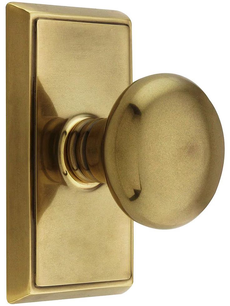 an antique brass door knob on a white background