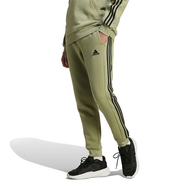 Whether it's a chilly day or you just want extra comfort, these adidas pants are your pick. Made from a soft cotton blend in fluffy fleece, they welcome all-day wear without a second thought. The mid-rise fit is finished with an elastic waist, and the legs taper to ribbed cuffs that let you show off your shoes.Click on this MEN'S GUIDE to find the perfect fit and more! TECHNOLOGIES & FEATURES Fleece 2 side pockets, 1 mobile pocket Ribbed cuffsFIT & SIZING 30-in. inseam Midrise sits above the hip Adidas Hose, Cuff Pants, Cotton Farming, Cuffed Pants, Mens Essentials, Fleece Joggers, Adidas Pants, Bottom Clothes, Bottoms Pants