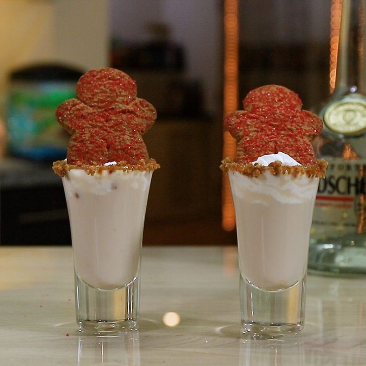 two glasses filled with dessert sitting on top of a counter