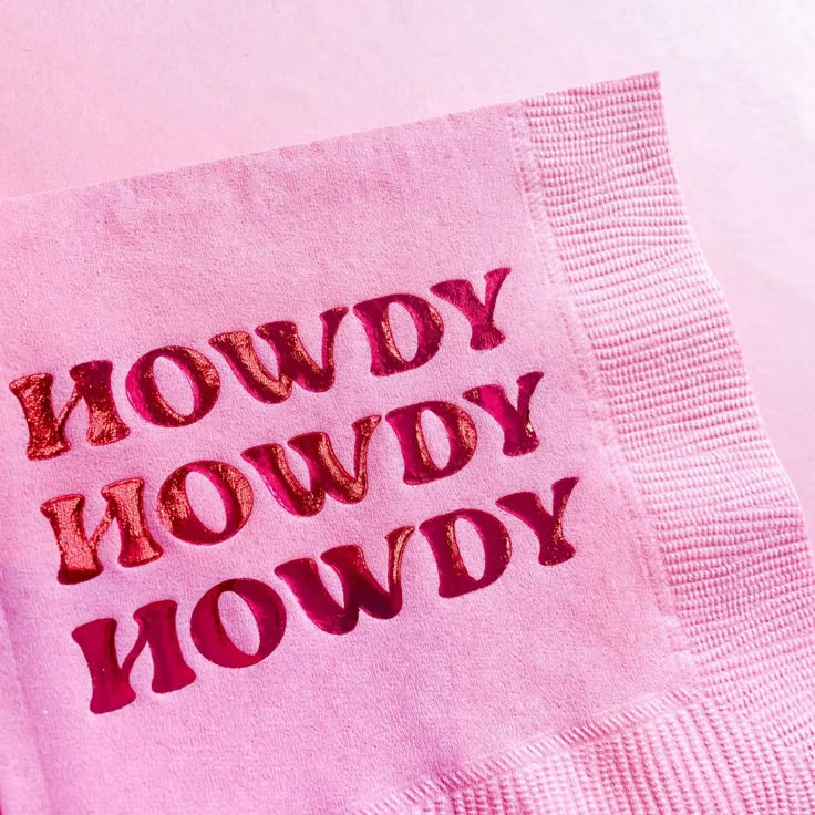 a pink napkin with the words hoddyy howdy on it