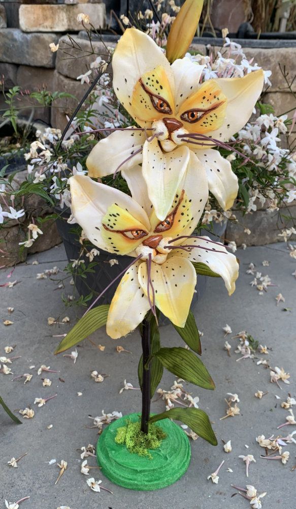 there is a vase with flowers in it on the ground