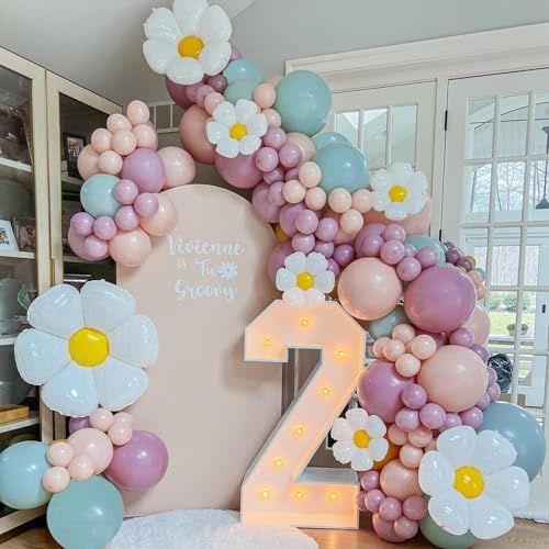 balloons and flowers are arranged around the number two