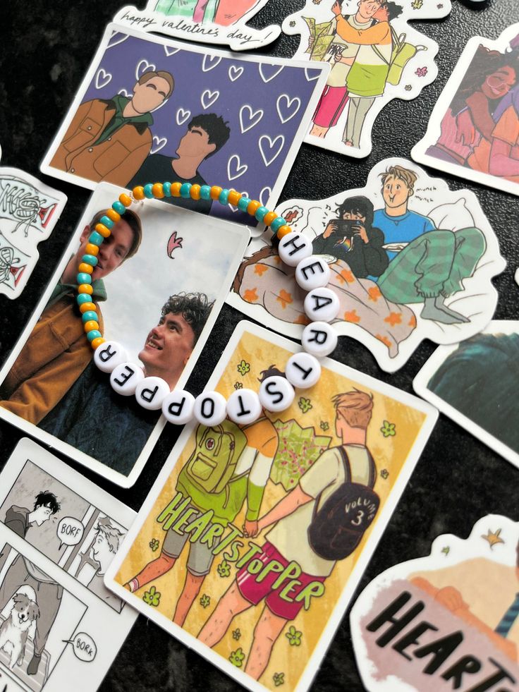 some pictures and beads are laying on the table with magnets attached to them that say happy new year