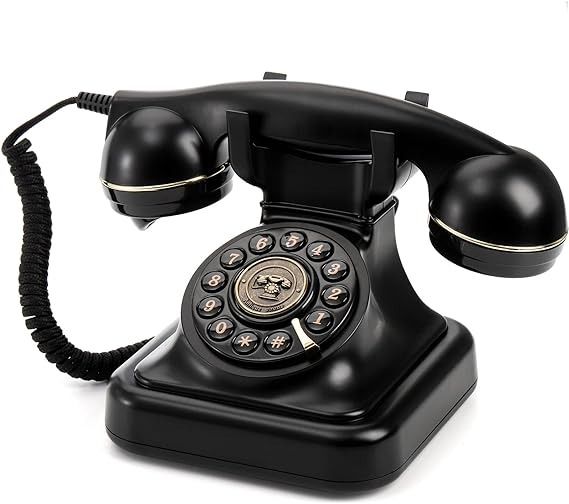 an old - fashioned black telephone is shown on a white background