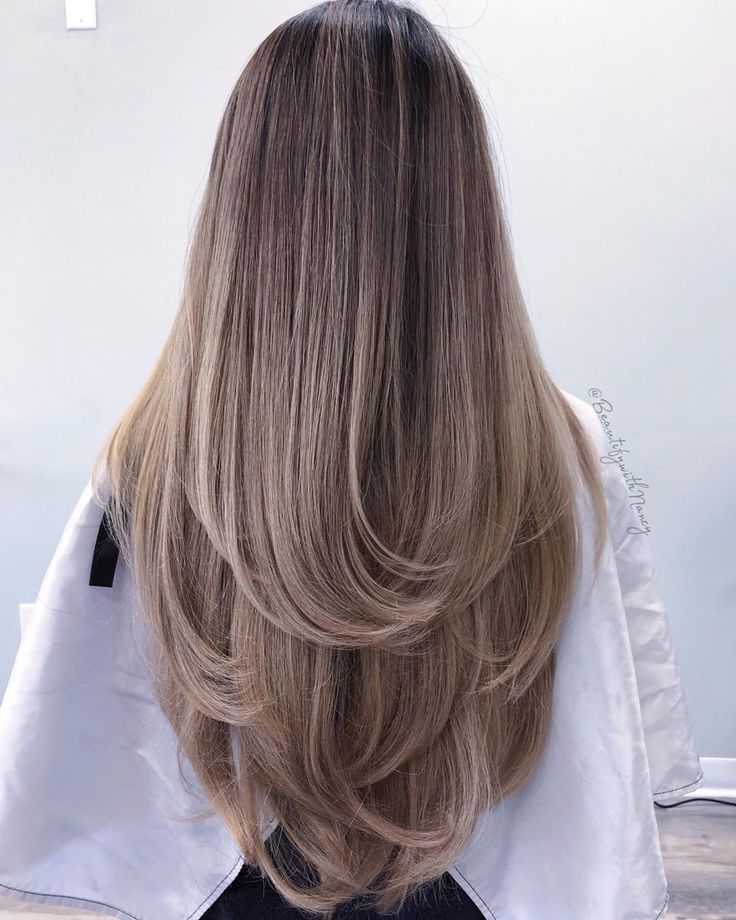 the back of a woman's head with long, blonde hair in front of her