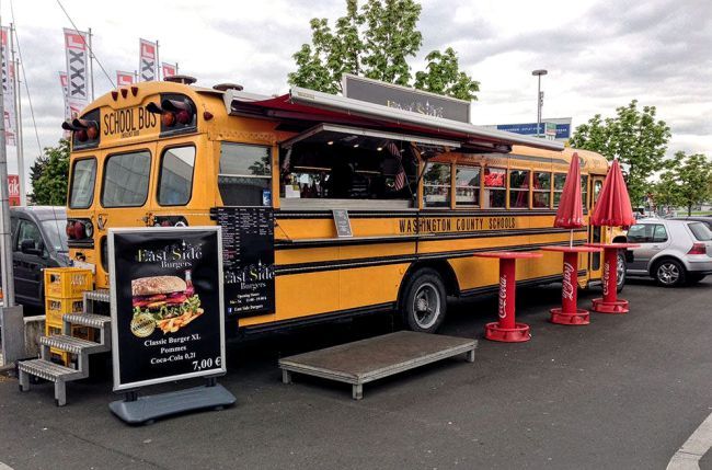 a yellow food truck parked in a parking lot