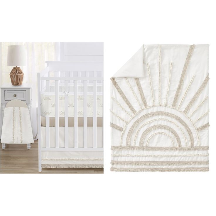 a white crib bedding set with an image of a sunburst on it