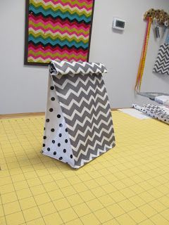 a large bag sitting on top of a yellow mat in front of a wall mounted art piece