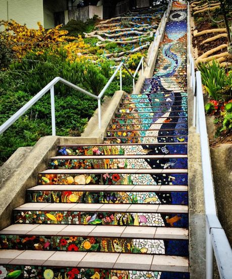 the stairs are painted with colorful designs on them and have handrails that lead up to the top