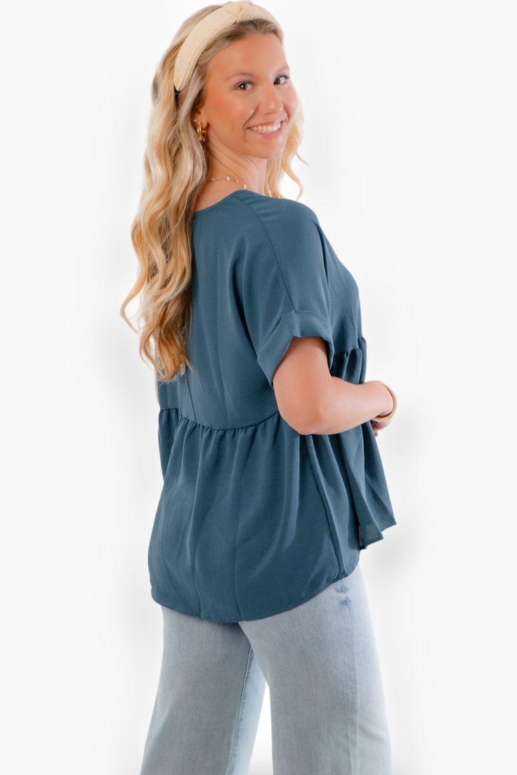 Get ready to elevate your style with our Chants Up Teal Short Sleeve Top ! This Entro Women's Short Sleeve Babydoll Tunic Top is a must-have addition to your wardrobe. The V-neckline and short rolled sleeves give it a trendy and casual look, while the flattering a-line flowy baby doll silhouette adds a touch of elegance and femininity. Made from lightweight 100% polyester, this top is perfect for staying cool and comfortable all day long. Whether you're dressing it up or down, this teal top will Fitted Short Sleeve V-neck Top For Work, Flowy Solid Color Tops, Casual V-neck Short Sleeve Top For Work, Spring V-neck Top With Short Sleeves, Spring V-neck Short Sleeve Top For Work, Solid Color Short Sleeve V-neck Top For Spring, Flowy Solid Color Short Sleeve Tops, Solid Short Sleeve Flowy Tops, Versatile Rayon Tops For Daywear