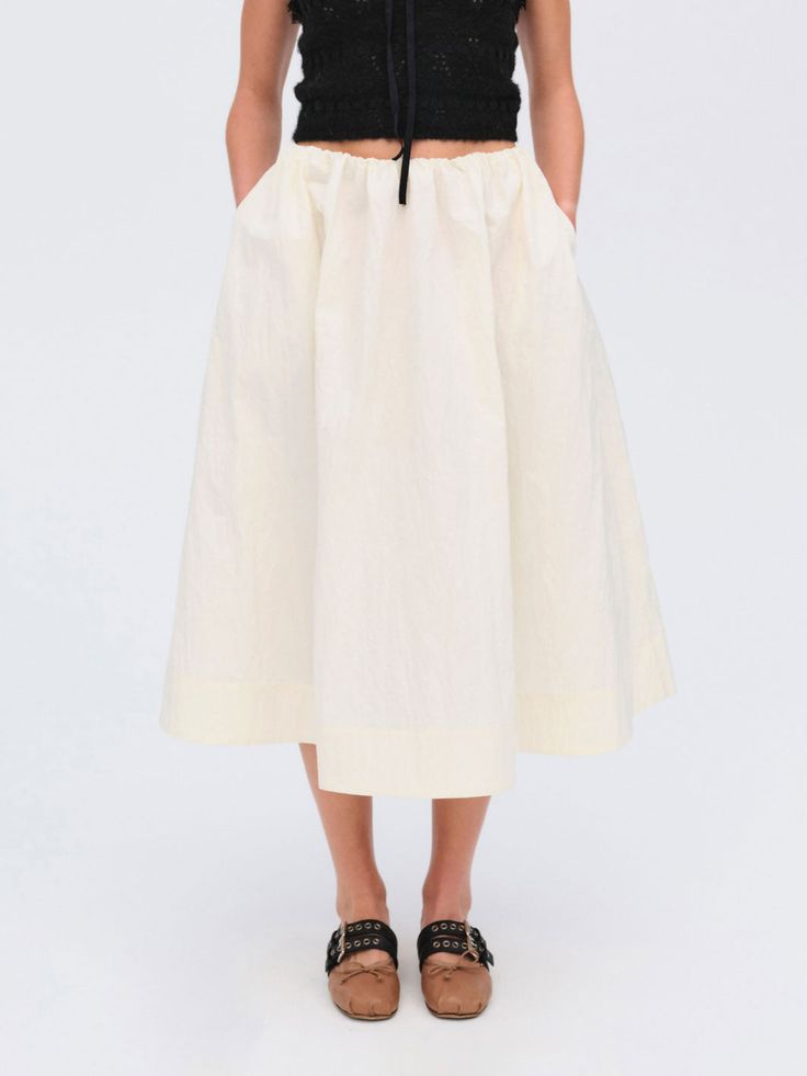 An ultra-chic transitional piece, the Billie cream midi skirt is crafted in a crisp, crinkle stretch poplin flares out into a full gathered skirt. Pair it with a contrasting colored top for a chic, seasonal look. Spring Daywear Maxi Skirt With Gathered Design, Spring Voluminous Pleated Skirt With Elastic Waistband, Chic Midi-length Cotton Maxi Skirt, Chic Cotton Maxi Skirt Midi Length, Chic Cotton Maxi Skirt In Midi Length, Cream Relaxed Maxi Skirt For Spring, Relaxed Cream Maxi Skirt For Spring, Off White Relaxed Skirt For Spring, Off White Relaxed Fit Skirt For Spring