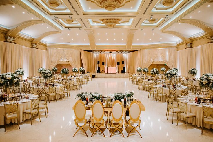 a banquet hall with tables and chairs set up for an event